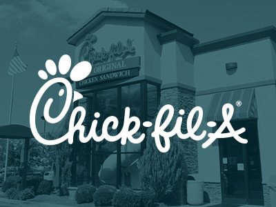 Chick-Fil-A logo with Chick-Fil-A franchise in the background.