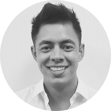 A black and white photo of a man smiling.