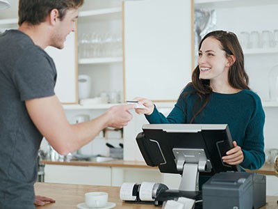 Employee helping customer pay at the POS.