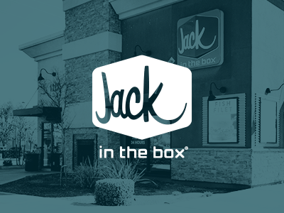 Jack in the Box logo with restaurant franchise in the background.