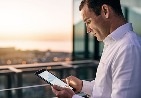 Businessman using his phone as business remote monitoring system.