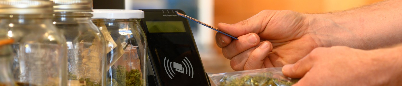 A person is using a smartphone to pay for marijuana.