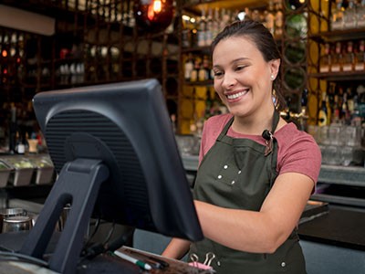 Restaurant worker using a modern pos system.