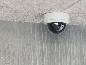 Cctv camera on the ceiling of a building.