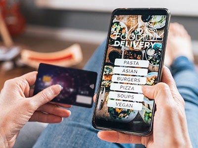 Consumer ordering food online on their phone.