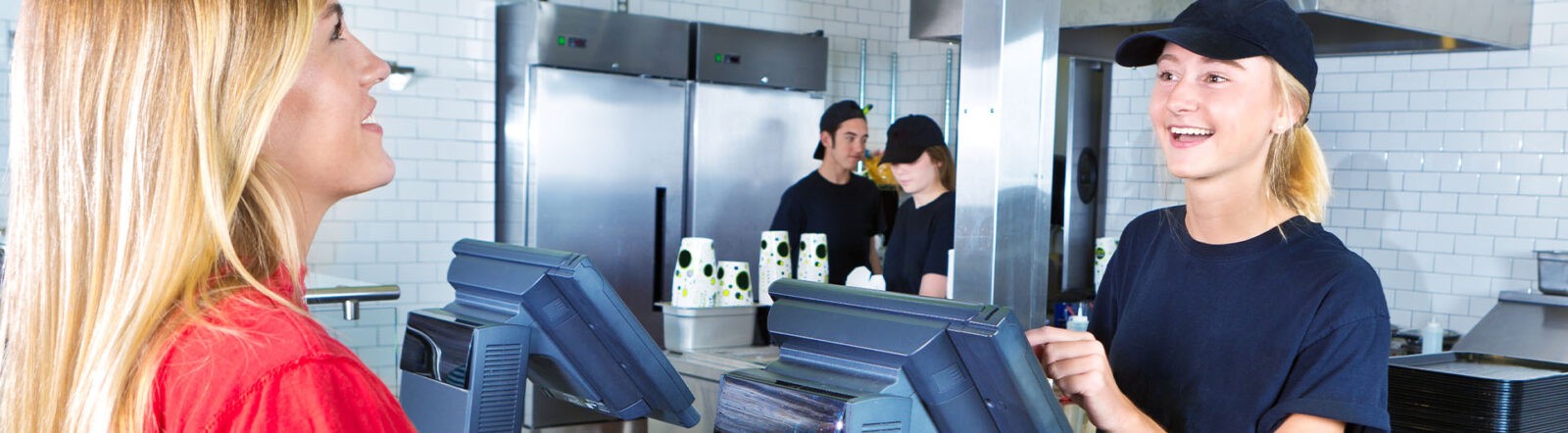 QSR employee serving an customer at the POS counter.