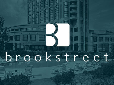 Brookstreet Hotel logo with hotel in the background.
