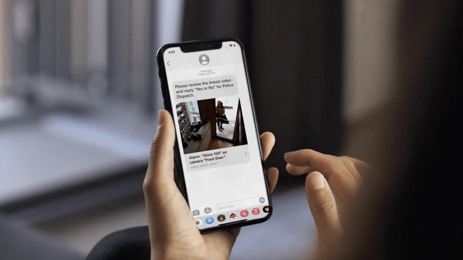 A woman holding a phone with a message on it.