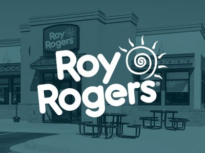 The logo for roy rogers on the side of a building.