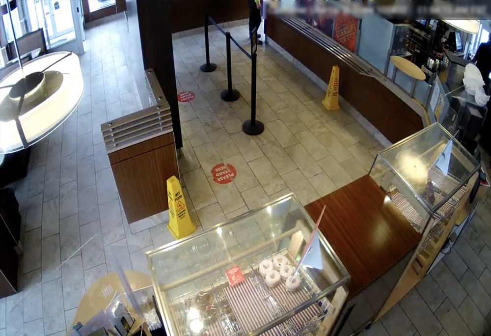A surveillance camera captures a donut shop.