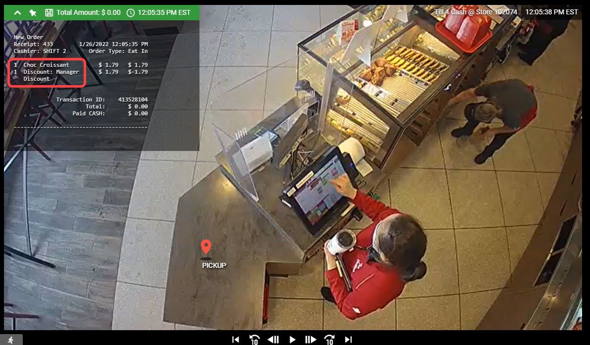 A screen shot of a surveillance camera showing a man in a red shirt.