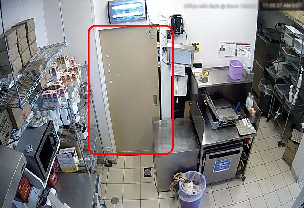 A camera captures a door in a restaurant.