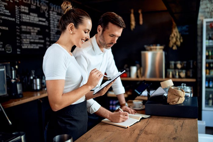 Small business owner doing bookkeeping at restaurant cafe.