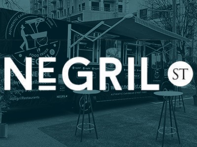 A black and white image of a food truck with the words negrill st.