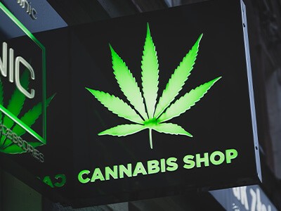 Cannabis shop sign with a green leaf on it.