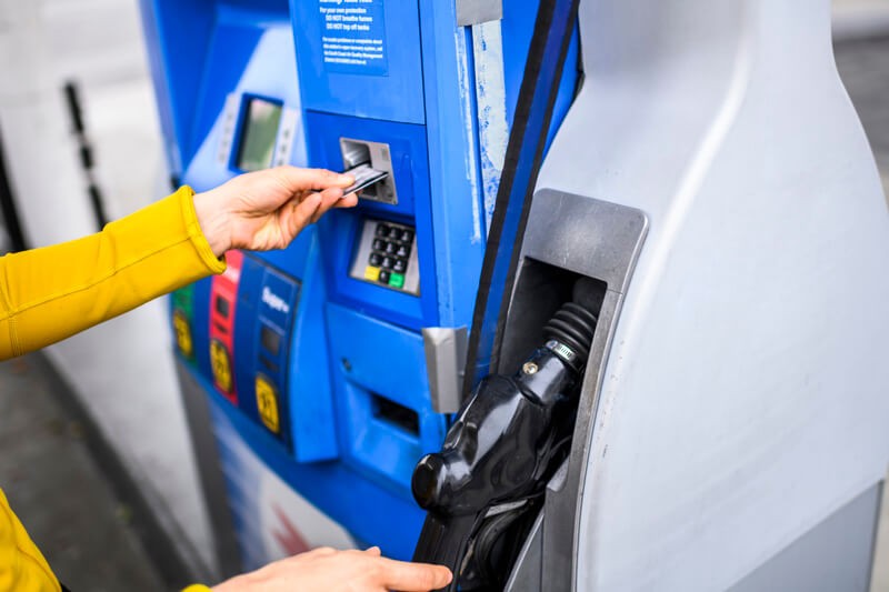 A person paying at the gas pump