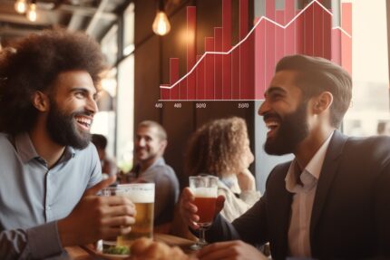 Two men drinking beer in a bar with a graph on the wall.