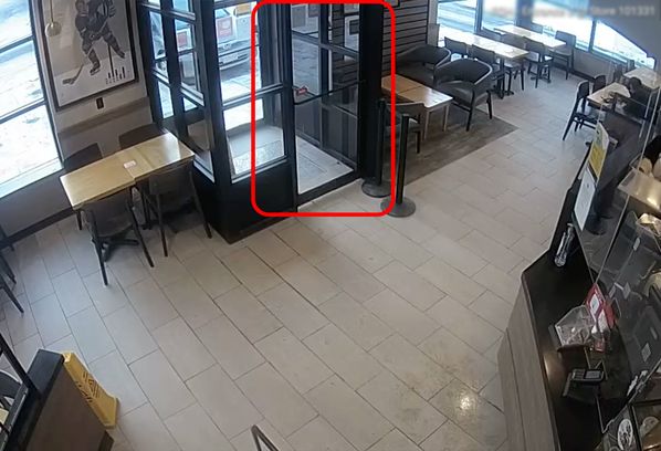 A surveillance camera shows a person in a restaurant.