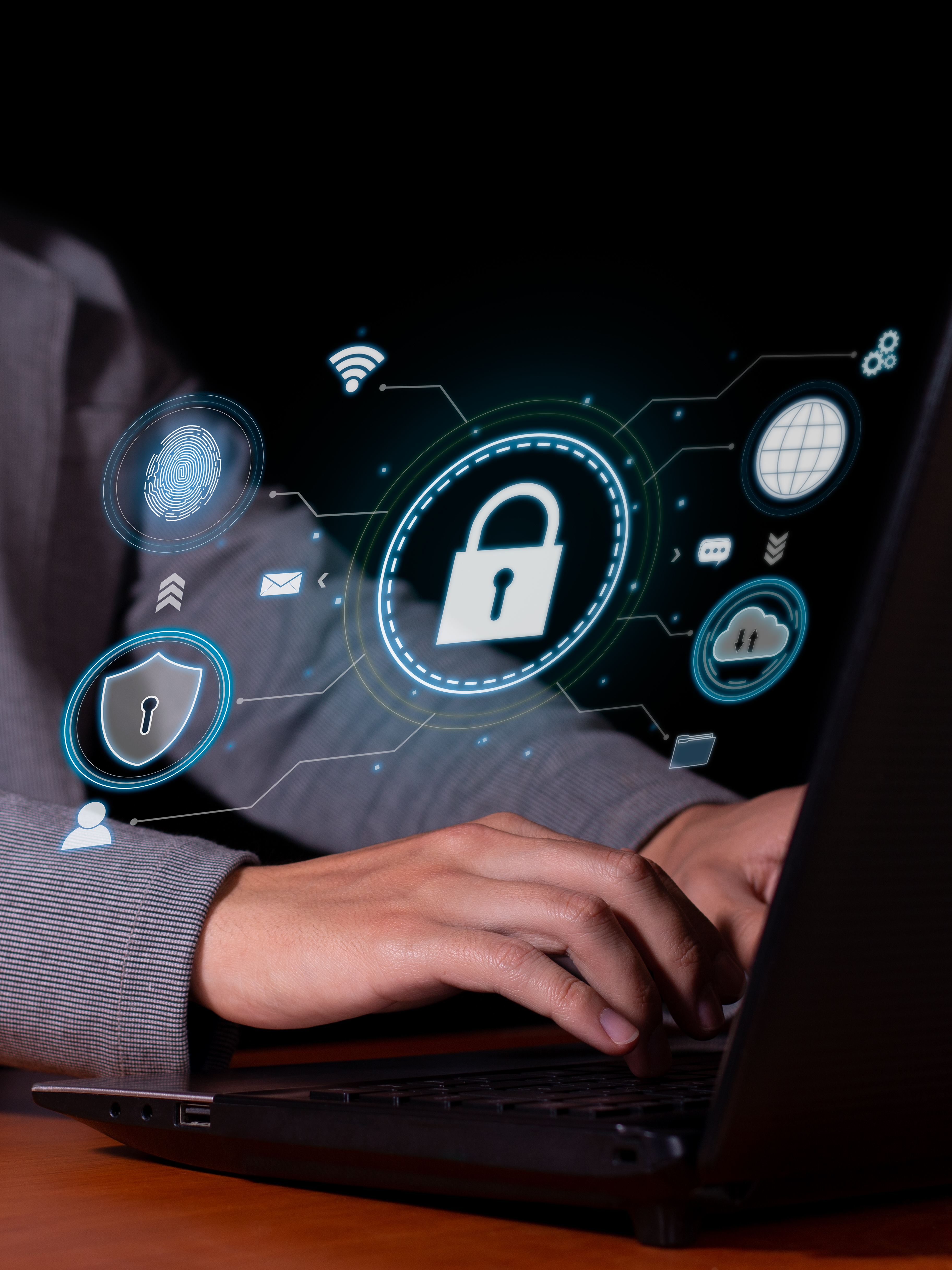 Hands typing on a laptop keyboard with digital security icons, including a lock, floating above the screen, representing cybersecurity and data protection concepts.