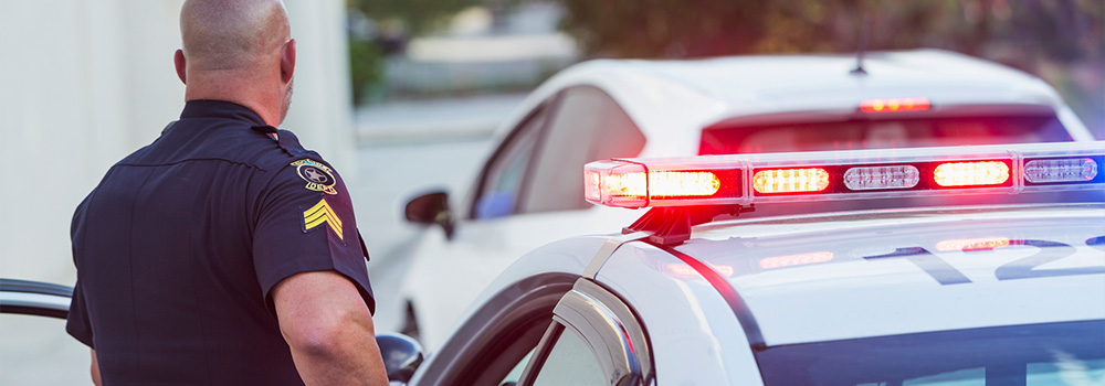 A cop and a police car