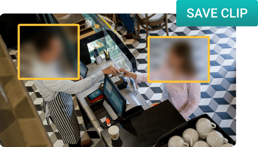 A customer making a payment at a cafe counter, with a barista operating the cash register. Cups are visible on the counter.