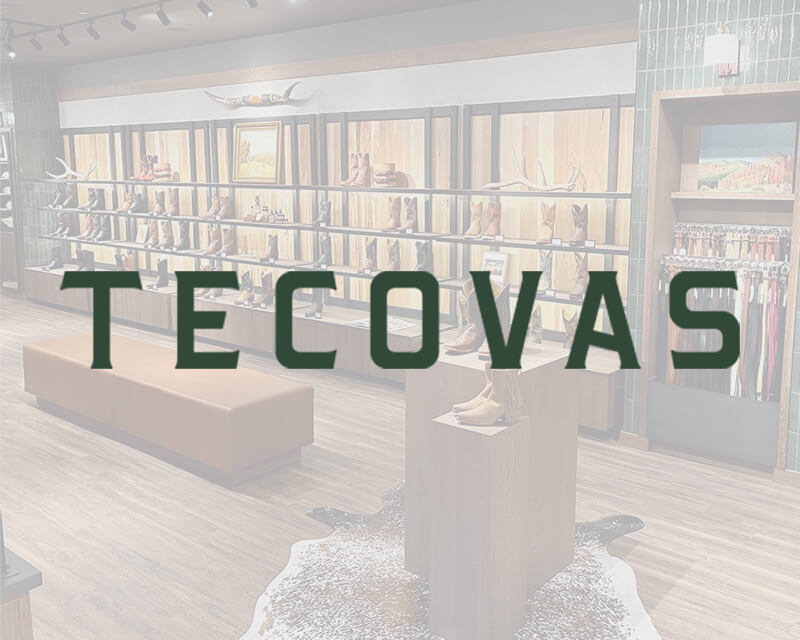 Store interior with shelves of boots and accessories; TECOVAS logo overlaid on the image.