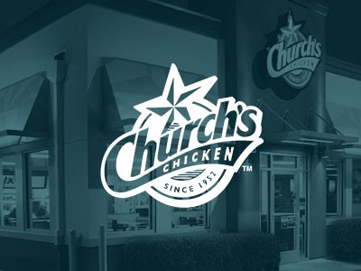 Exterior view of a Church's Chicken restaurant with prominent logo and signage.