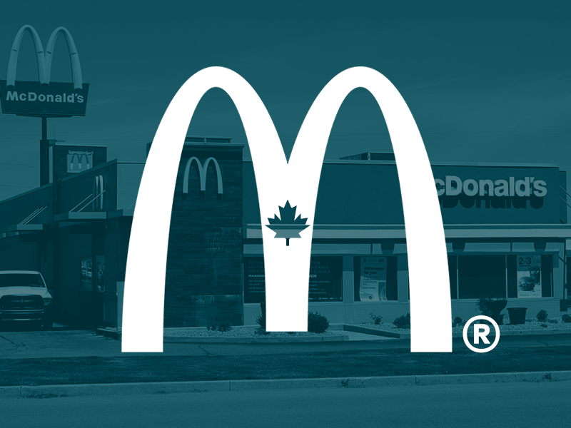 White McDonald's logo with a maple leaf in the center over a teal-tinted image of a McDonald's restaurant exterior.