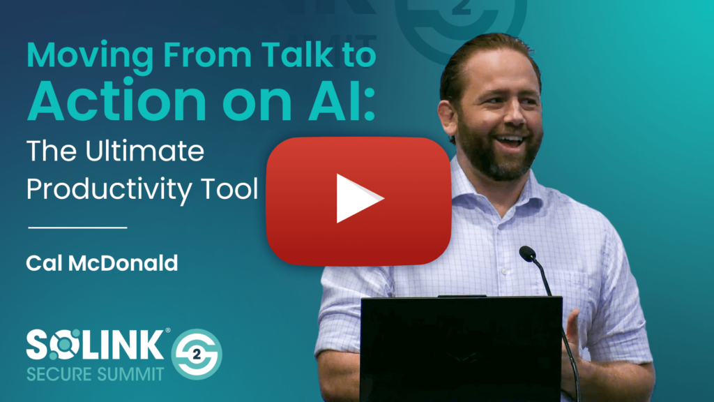 A man stands at a podium giving a presentation titled "Moving From Talk to Action on AI: The Ultimate Productivity Tool" at the Solink Secure Summit.