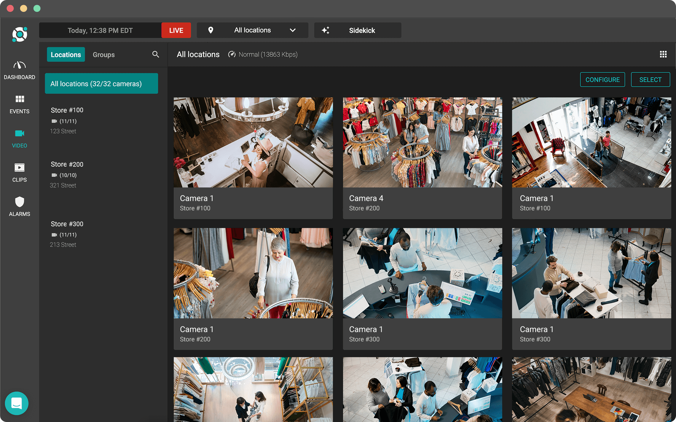 A computer dashboard displays live surveillance footage from multiple cameras inside retail stores, showing shoppers and staff in various aisles and clothing sections.