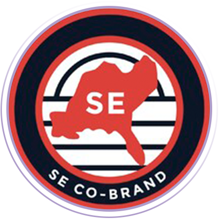 A circular logo featuring a red map outline labeled "SE" over black and white stripes, with the text "SE CO-BRAND" at the bottom.