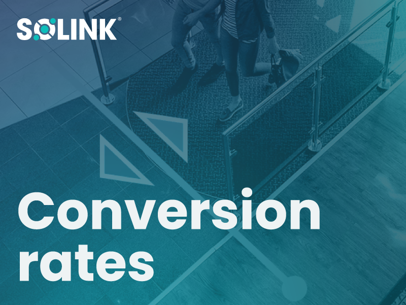Overhead view of people walking through a store entrance, with the text "SOLINK Conversion rates" overlaid on the image.