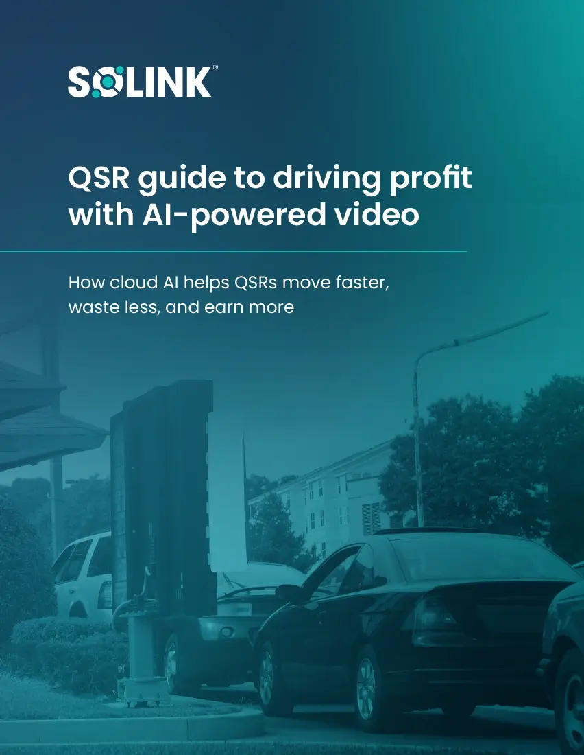 A drive-thru lane with cars waiting; the Solink QSR guide discusses how cloud AI video helps quick service restaurants increase profit, efficiency, and reduce waste.