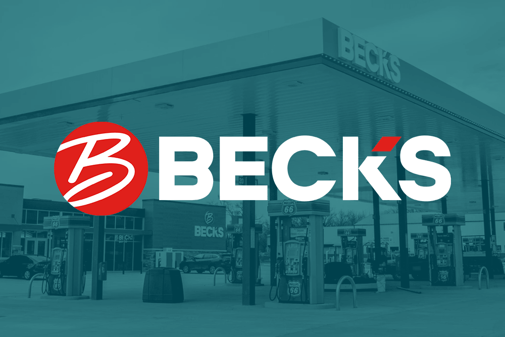 A Beck's gas station with fuel pumps under a large canopy, featuring the Beck's logo prominently in the foreground.