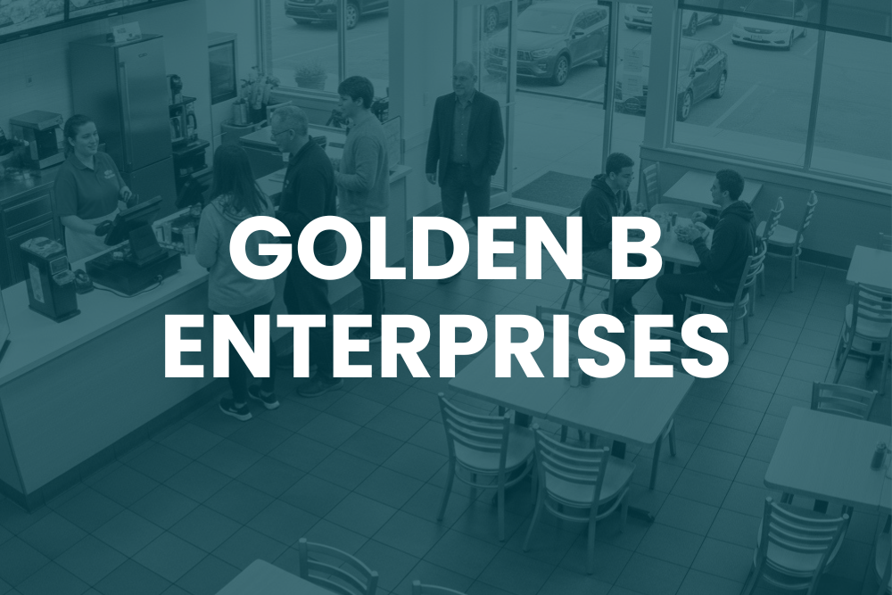 Several people stand and sit inside a fast food restaurant. Large text overlay reads "GOLDEN B ENTERPRISES.
