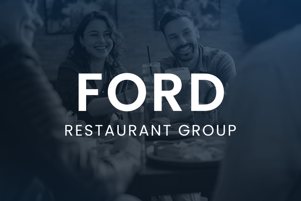 People sitting at a restaurant table smiling, with the text “FORD RESTAURANT GROUP” overlaid in large white letters.